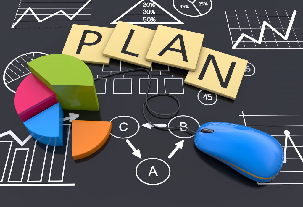 plan board with pc mouse, letters and a graph cake